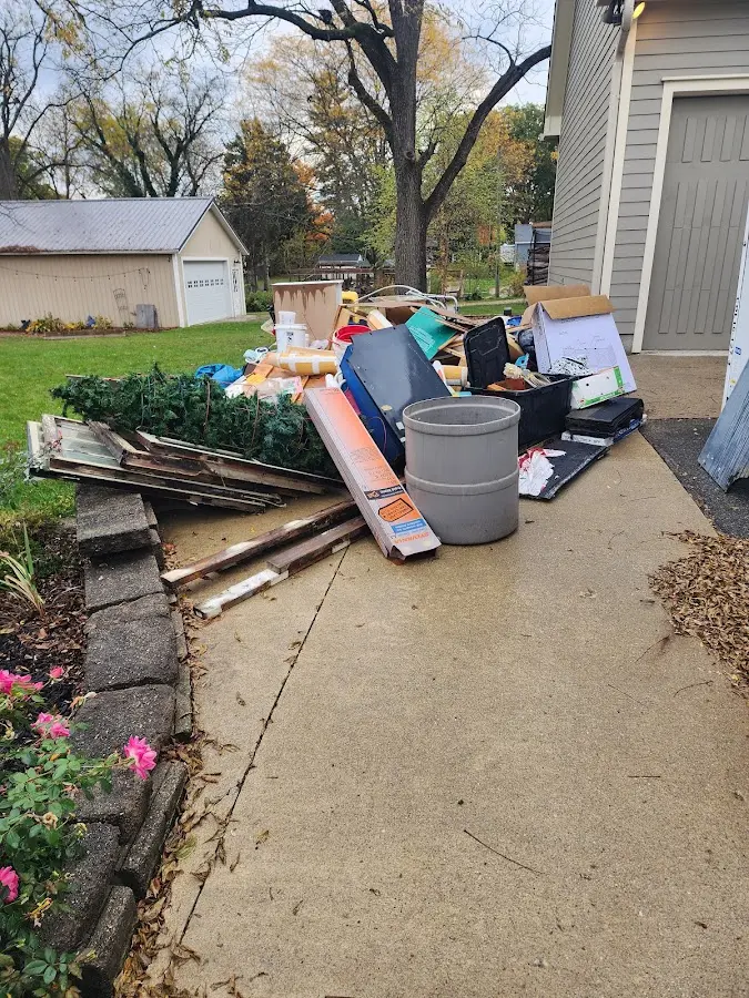 Dumpster being loaded with debris for 12 Yard Dumpster Rental in Meadowbrook